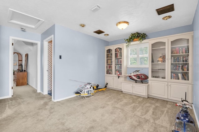 13533 Bay Lake Ln, Tampa, FL 33618 - recreation room featuring attic access, light carpet, and baseboards
