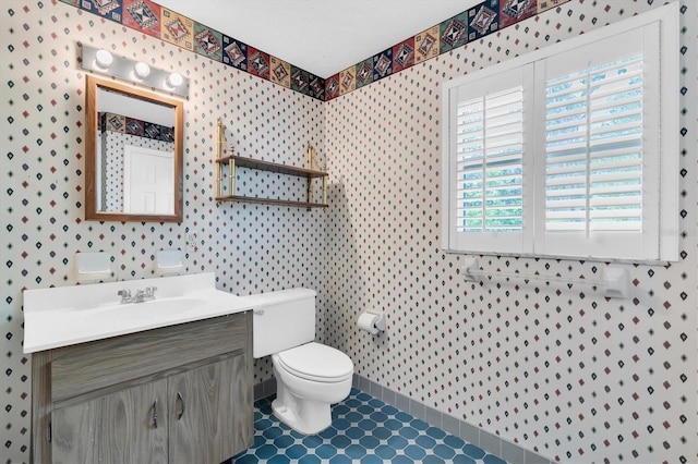 13533 Bay Lake Ln, Tampa, FL 33618 - bathroom featuring toilet, vanity, wallpapered walls, and tile patterned floors