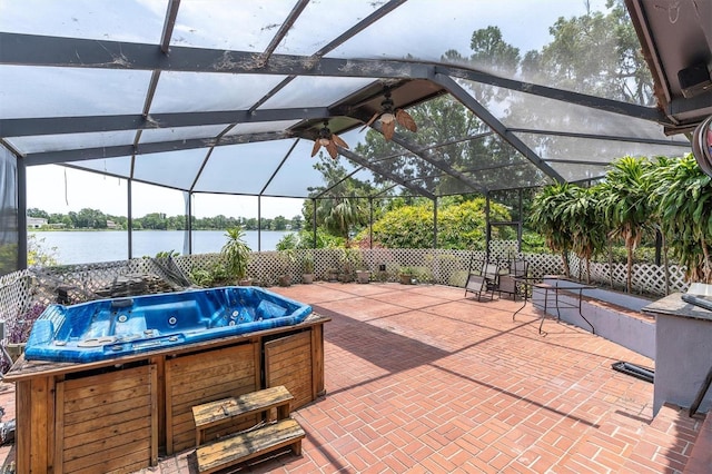 13533 Bay Lake Ln, Tampa, FL 33618 - view of patio featuring a hot tub, a water view, and glass enclosure
