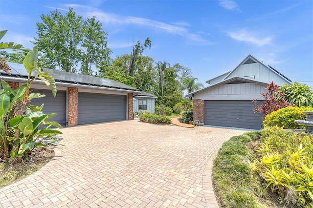 13533 Bay Lake Ln, Tampa, FL 33618 - garage with decorative driveway and solar panels