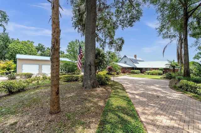 13533 Bay Lake Ln, Tampa, FL 33618 - view of front of home featuring metal roof and a chimney
