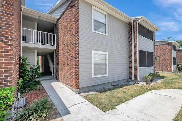 1400 Gandy Blvd N Unit 1504, Saint Petersburg, FL 33702 - view of side of property featuring brick siding and a balcony