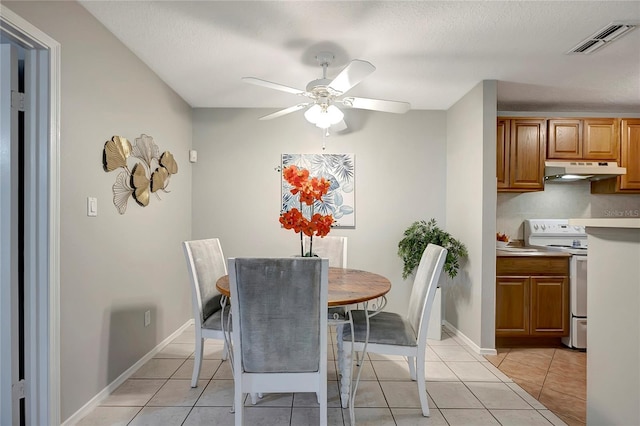 1400 Gandy Blvd N Unit 1504, Saint Petersburg, FL 33702 - dining room with a ceiling fan, light tile patterned flooring, baseboards, and a textured ceiling