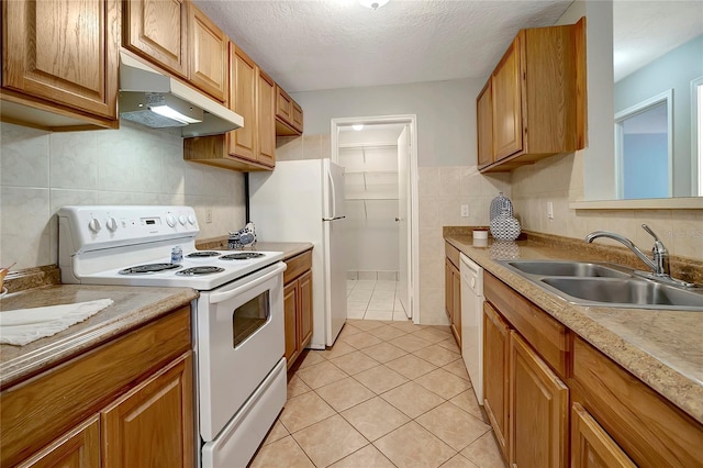 1400 Gandy Blvd N Unit 1504, Saint Petersburg, FL 33702 - kitchen featuring white appliances, under cabinet range hood, a sink, tile walls, and light tile patterned floors