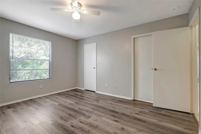 1400 Gandy Blvd N Unit 1504, Saint Petersburg, FL 33702 - unfurnished bedroom featuring wood finished floors, baseboards, and a ceiling fan