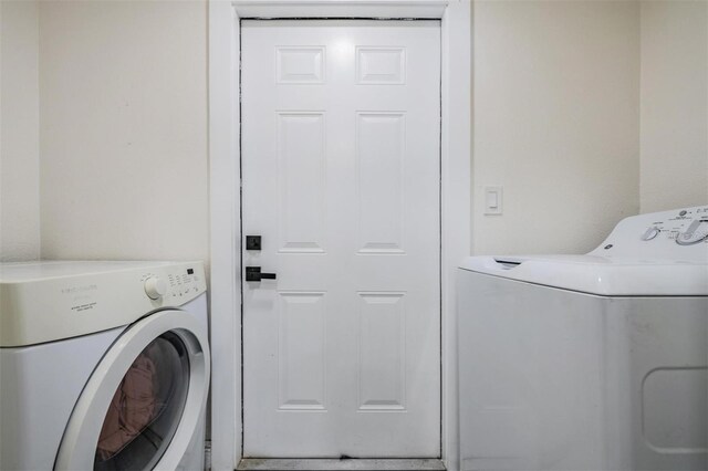 clothes washing area with independent washer and dryer