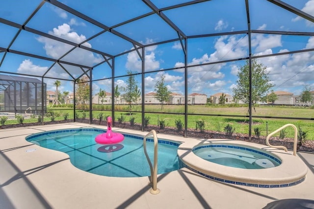 view of swimming pool featuring a pool with connected hot tub, a lanai, a patio area, and a residential view
