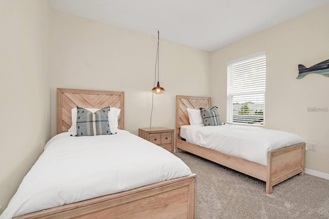 bedroom with carpet flooring and baseboards