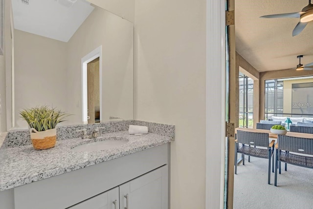 bathroom featuring ceiling fan and vanity