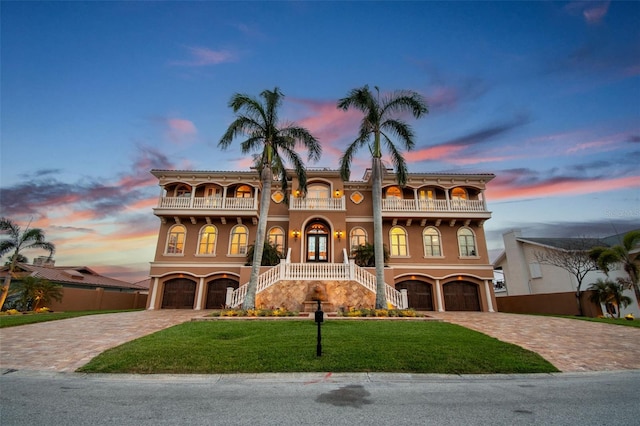 5810 Mariner St, Tampa, FL 33609 - mediterranean / spanish home featuring a balcony, stairway, decorative driveway, and a garage