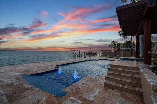 5810 Mariner St, Tampa, FL 33609 - pool at dusk featuring an outdoor pool, a patio area, and a water view