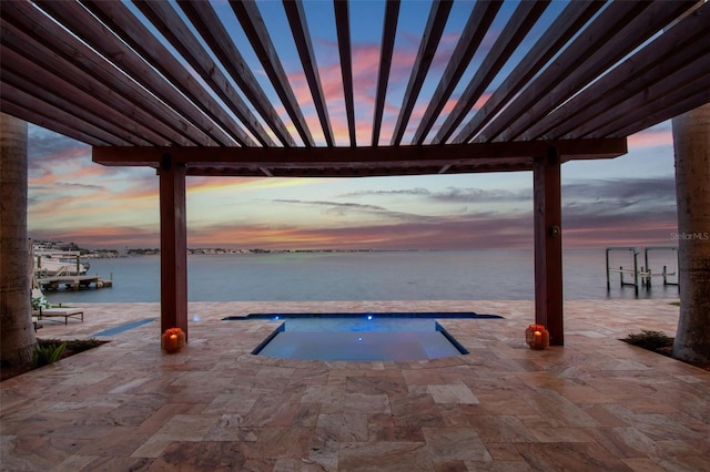 5810 Mariner St, Tampa, FL 33609 - pool at dusk with a water view, an in-ground hot tub, and a patio area