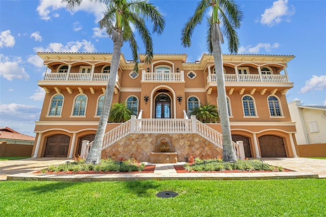 5810 Mariner St, Tampa, FL 33609 - mediterranean / spanish-style home with a balcony, stairway, stucco siding, and a garage