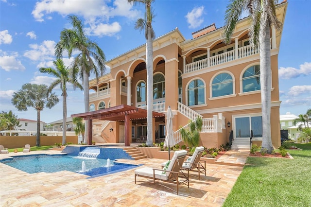5810 Mariner St, Tampa, FL 33609 - rear view of property with stairway, stucco siding, an outdoor pool, and a balcony