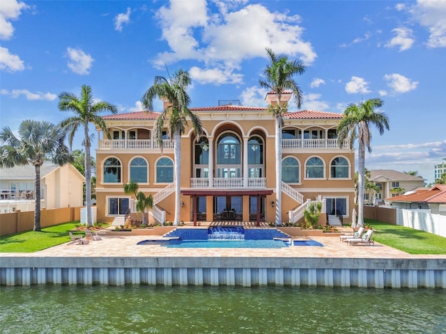 5810 Mariner St, Tampa, FL 33609 - back of house with stairs, a balcony, a fenced backyard, and stucco siding