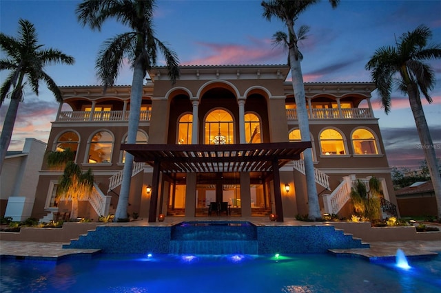 5810 Mariner St, Tampa, FL 33609 - rear view of property with stairway, a balcony, and an outdoor pool
