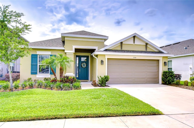 view of front facade with stucco siding, a garage, a front yard, and concrete driveway