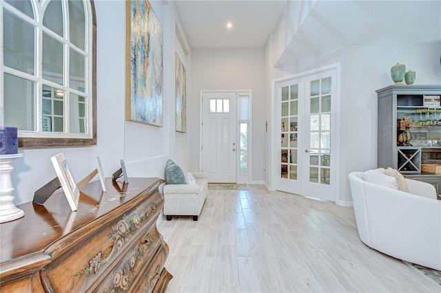 foyer entrance with french doors, baseboards, and recessed lighting