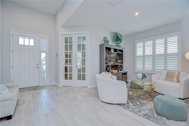 living room with french doors, baseboards, and recessed lighting