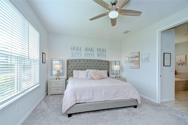 carpeted bedroom featuring multiple windows, baseboards, and ceiling fan