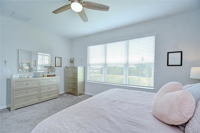 bedroom with light colored carpet, baseboards, and ceiling fan