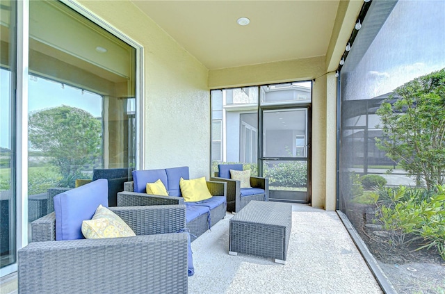 sunroom with healthy amount of natural light and an outdoor living space