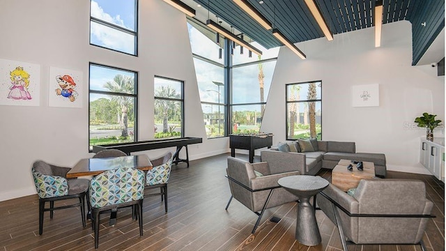 lobby with a towering ceiling and beamed ceiling