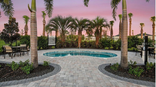 view of swimming pool with fence, a patio, and a swimming pool