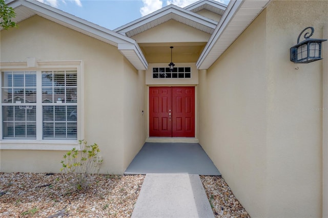 14614 Rannoch Moor Pl, Wimauma, FL 33598 - view of exterior entry with stucco siding