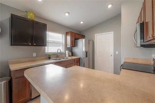 14614 Rannoch Moor Pl, Wimauma, FL 33598 - kitchen with stainless steel appliances, a peninsula, vaulted ceiling, light countertops, and recessed lighting