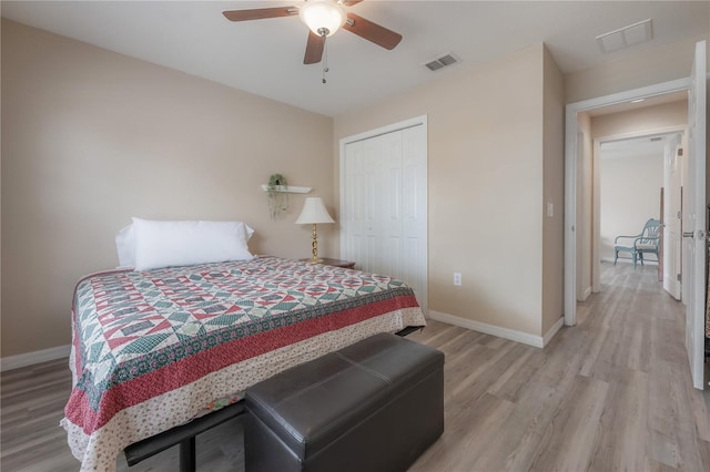 14614 Rannoch Moor Pl, Wimauma, FL 33598 - bedroom with light wood-style flooring, a closet, and a ceiling fan