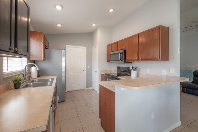 14614 Rannoch Moor Pl, Wimauma, FL 33598 - kitchen featuring black / electric stove, stainless steel microwave, light countertops, light tile patterned floors, and vaulted ceiling