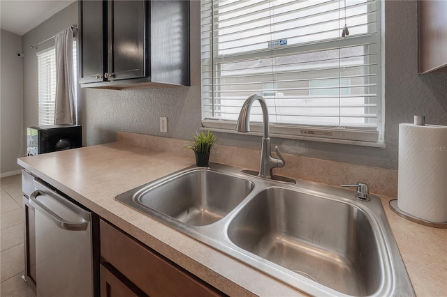 14614 Rannoch Moor Pl, Wimauma, FL 33598 - kitchen featuring stainless steel dishwasher, a textured wall, and light countertops