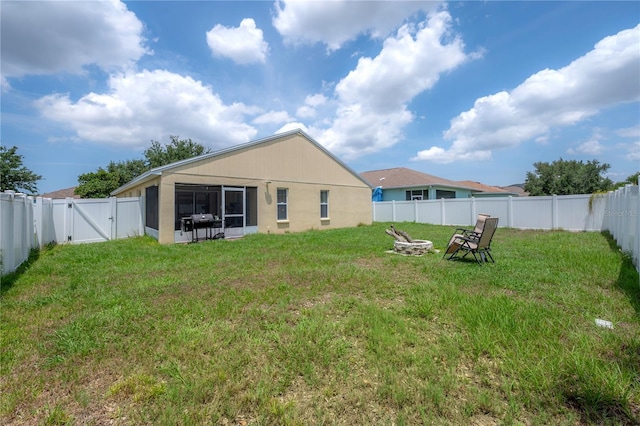 14614 Rannoch Moor Pl, Wimauma, FL 33598 - back of house featuring a gate, an outdoor fire pit, and a fenced backyard