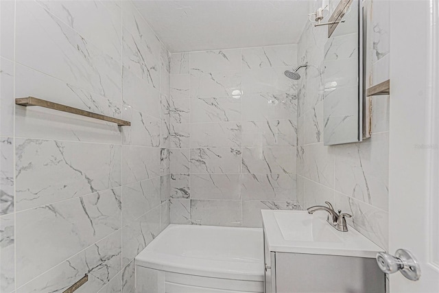 3315 58th Ave S Unit 605, Saint Petersburg, FL 33712 - bathroom featuring vanity, washtub / shower combination, and tile walls