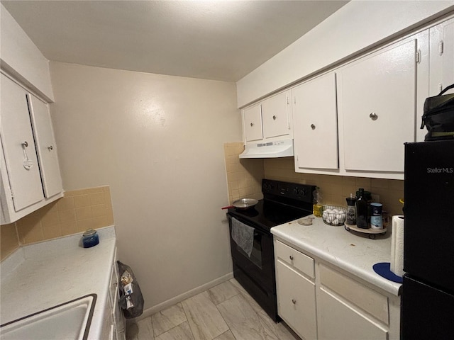 5901 E Gibson Ave, Tampa, FL 33617 - kitchen featuring black appliances, under cabinet range hood, white cabinets, tasteful backsplash, and light countertops