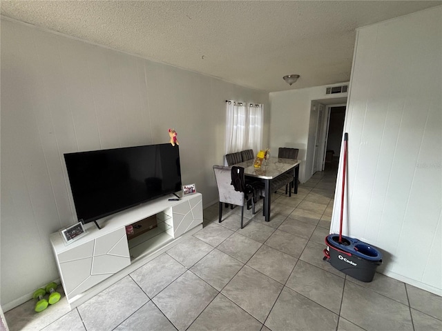 5901 E Gibson Ave, Tampa, FL 33617 - dining room featuring light tile patterned floors and a textured ceiling