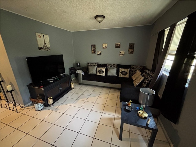 5901 E Gibson Ave, Tampa, FL 33617 - living area featuring a textured ceiling, light tile patterned flooring, and baseboards