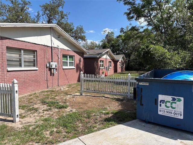 5901 E Gibson Ave, Tampa, FL 33617 - view of side of property with fence and brick siding