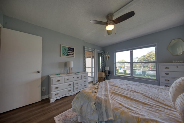 bedroom featuring a textured ceiling, dark wood-style floors, access to outside, ceiling fan, and baseboards