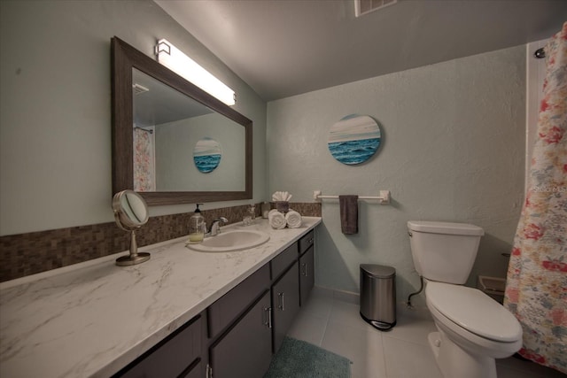 bathroom with vanity, toilet, and tile patterned floors