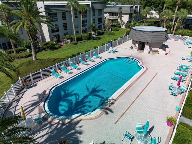 community pool featuring fence and a patio area
