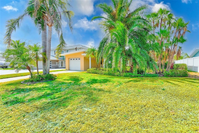 365 La Hacienda Dr, Indian Rocks Beach, FL 33785 - view of front facade with an attached garage, stucco siding, and concrete driveway