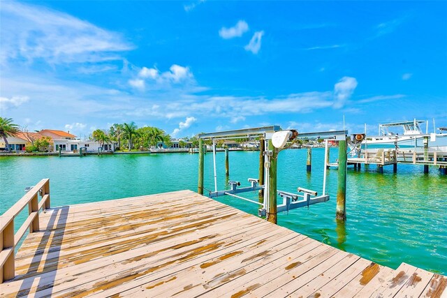365 La Hacienda Dr, Indian Rocks Beach, FL 33785 - dock featuring boat lift and a water view