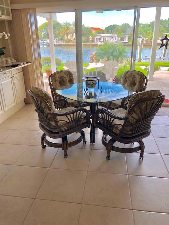 365 La Hacienda Dr, Indian Rocks Beach, FL 33785 - dining area with healthy amount of natural light, a water view, and light tile patterned flooring