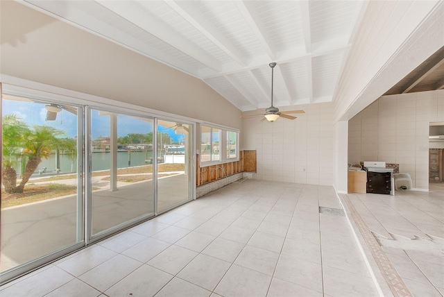 365 La Hacienda Dr, Indian Rocks Beach, FL 33785 - unfurnished living room featuring a water view, ceiling fan, tile walls, and tile patterned floors