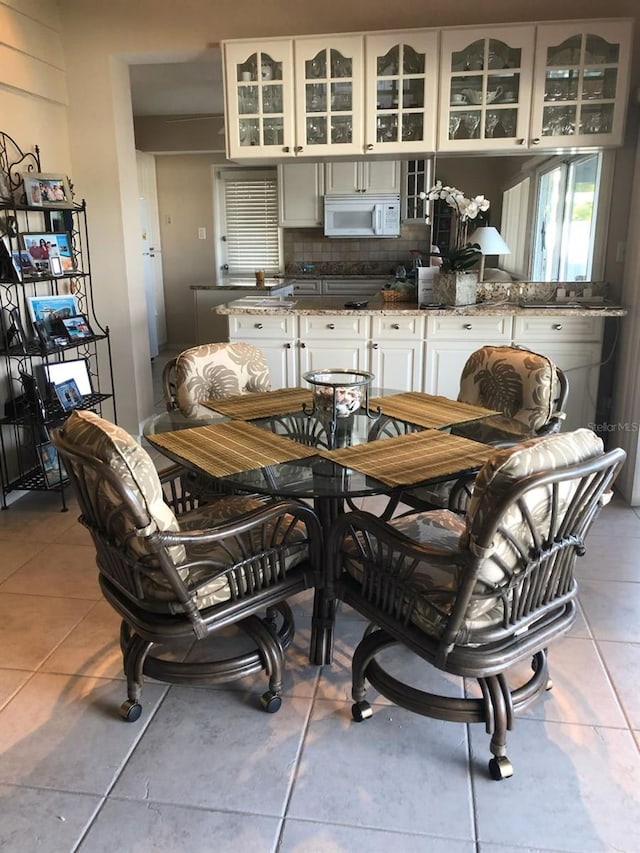 365 La Hacienda Dr, Indian Rocks Beach, FL 33785 - dining area with light tile patterned flooring