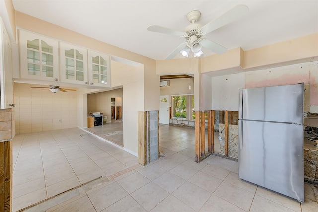 365 La Hacienda Dr, Indian Rocks Beach, FL 33785 - kitchen with freestanding refrigerator, ceiling fan, light tile patterned floors, and glass insert cabinets
