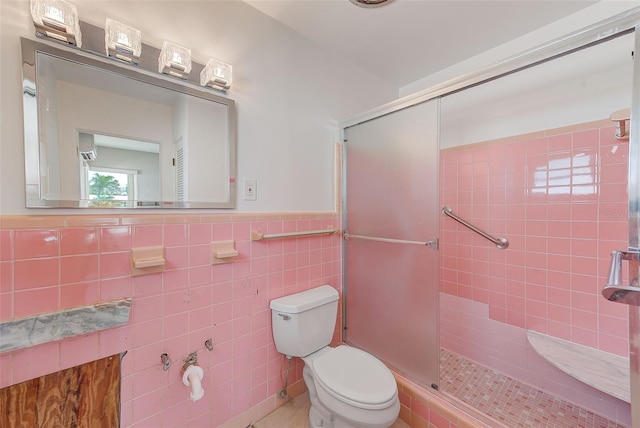 365 La Hacienda Dr, Indian Rocks Beach, FL 33785 - full bathroom with a shower stall, toilet, a wainscoted wall, and tile walls