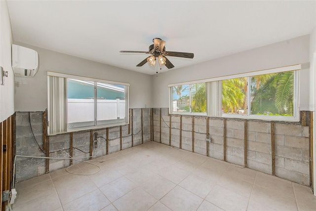 365 La Hacienda Dr, Indian Rocks Beach, FL 33785 - spare room featuring a wall mounted AC, a ceiling fan, a wainscoted wall, and tile patterned flooring